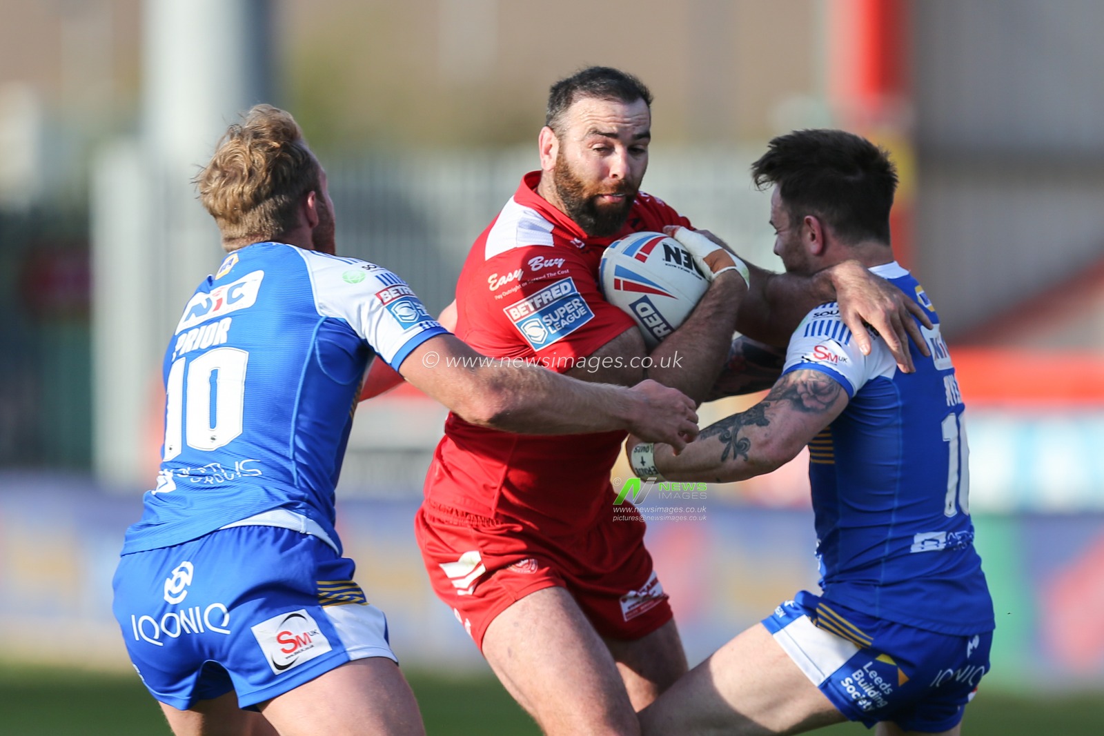 Kane Linnett (12) of Hull KR runs at the Leeds defence