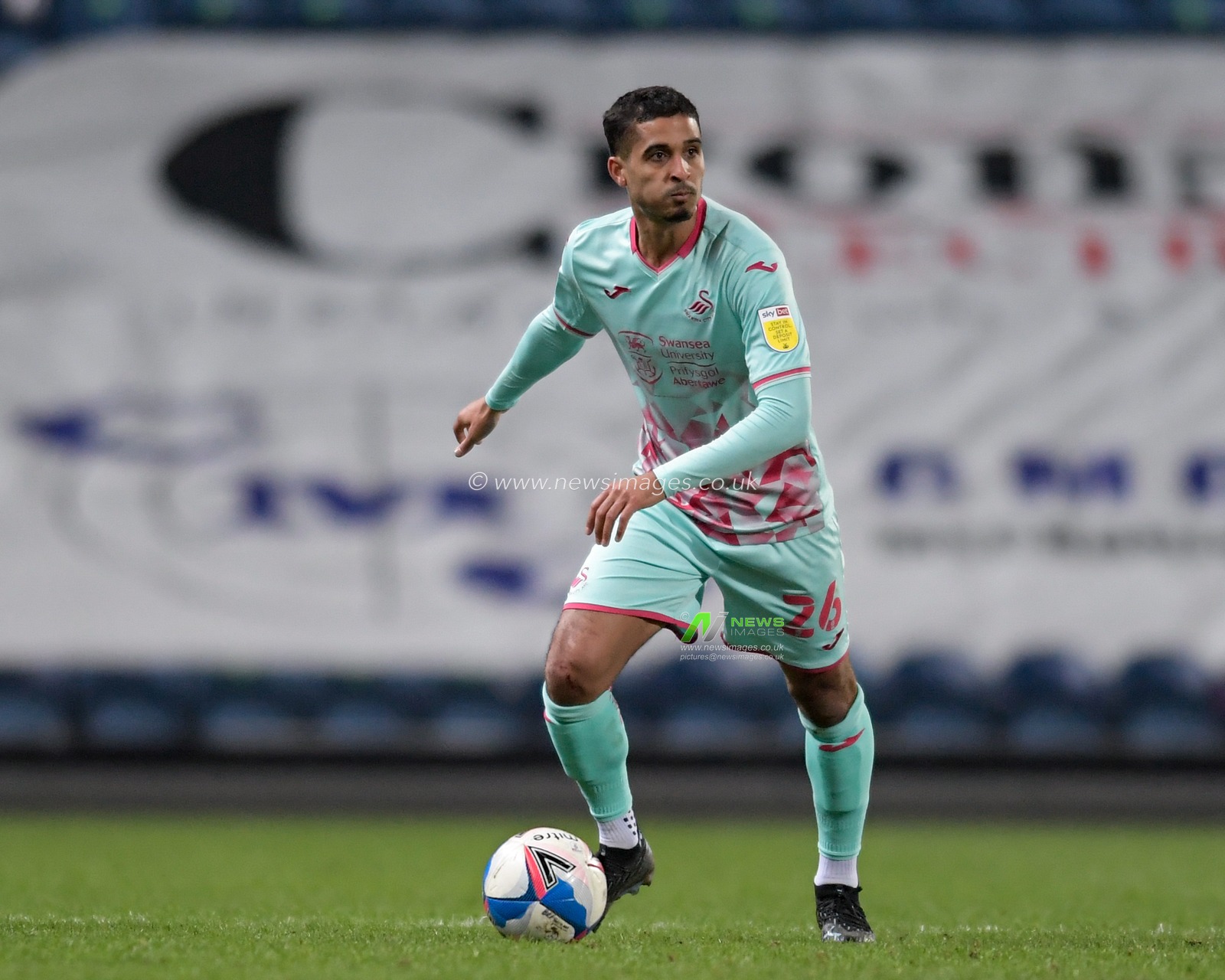 Kyle Naughton #26 of Swansea City looks for a passing option