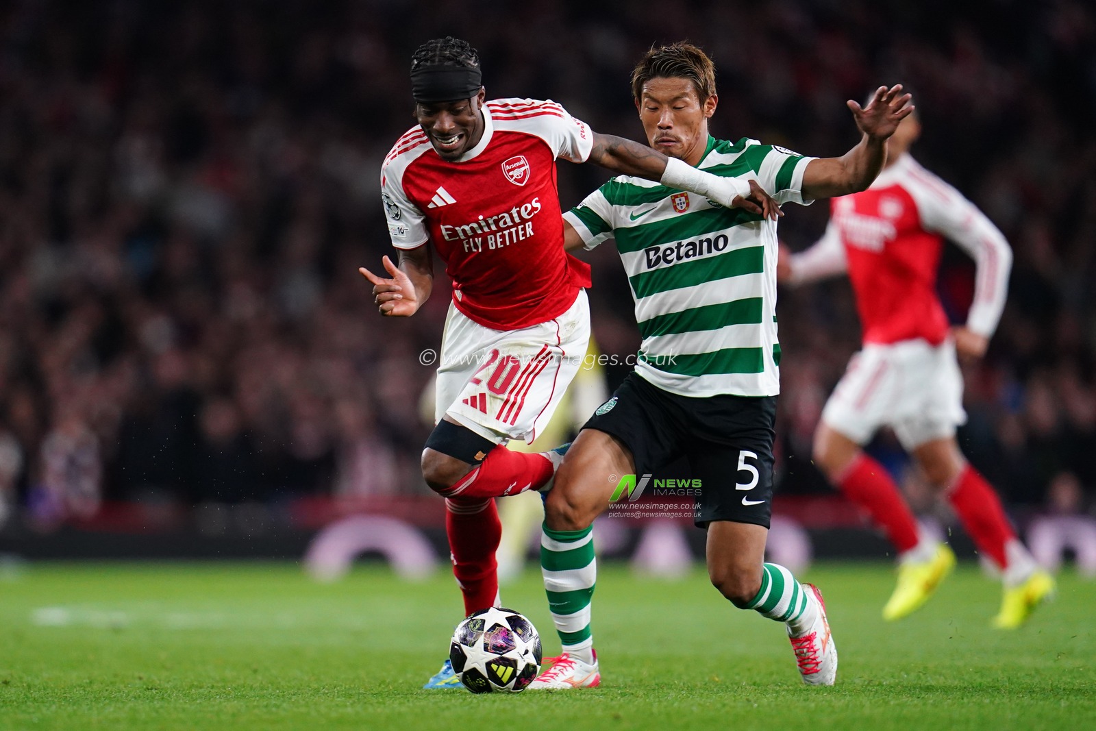 Noni Madueke of Arsenal and Hidemasa Morita of Sporting CP battle during the UEFA Champions League Quarter Finals match Arsenal vs Sporting CP at Arsenal stadium, London, United Kingdom on 15 April 2026

(Photo by Harvey Murphy/News Images)