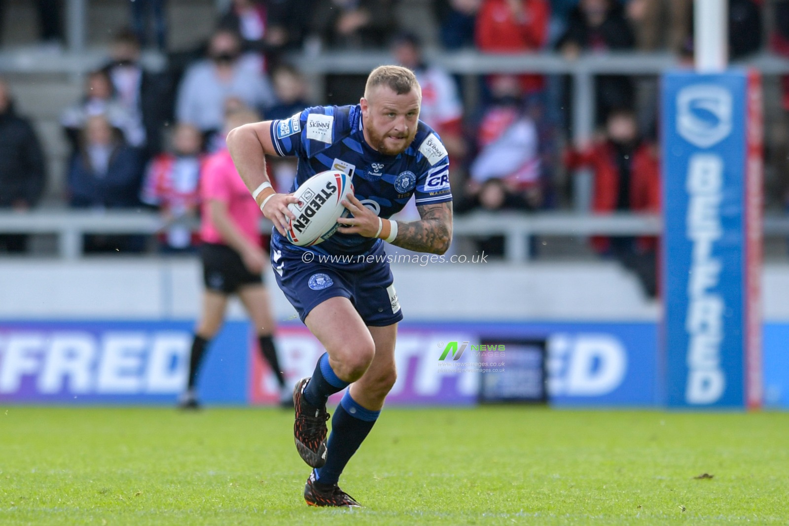 Brad Singleton (8) of Wigan Warriors runs forward with the ball