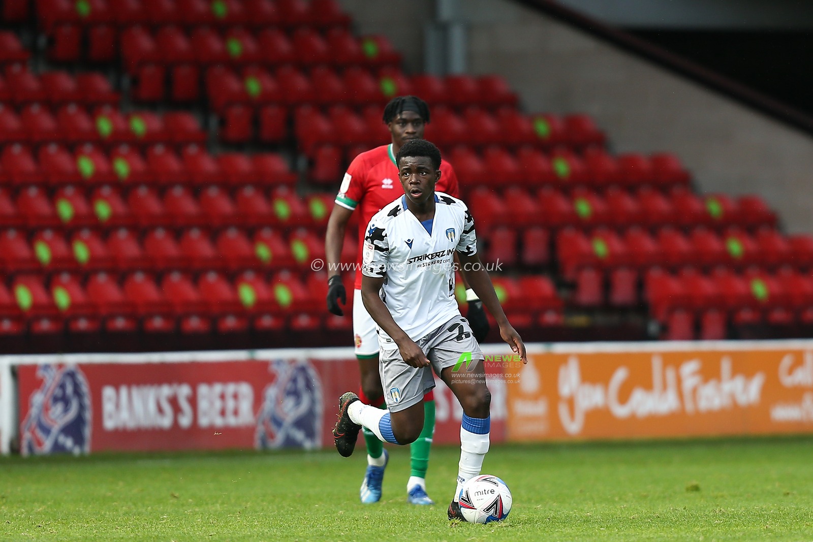 Kwame Poku (23) of Colchester United dribbles the ball