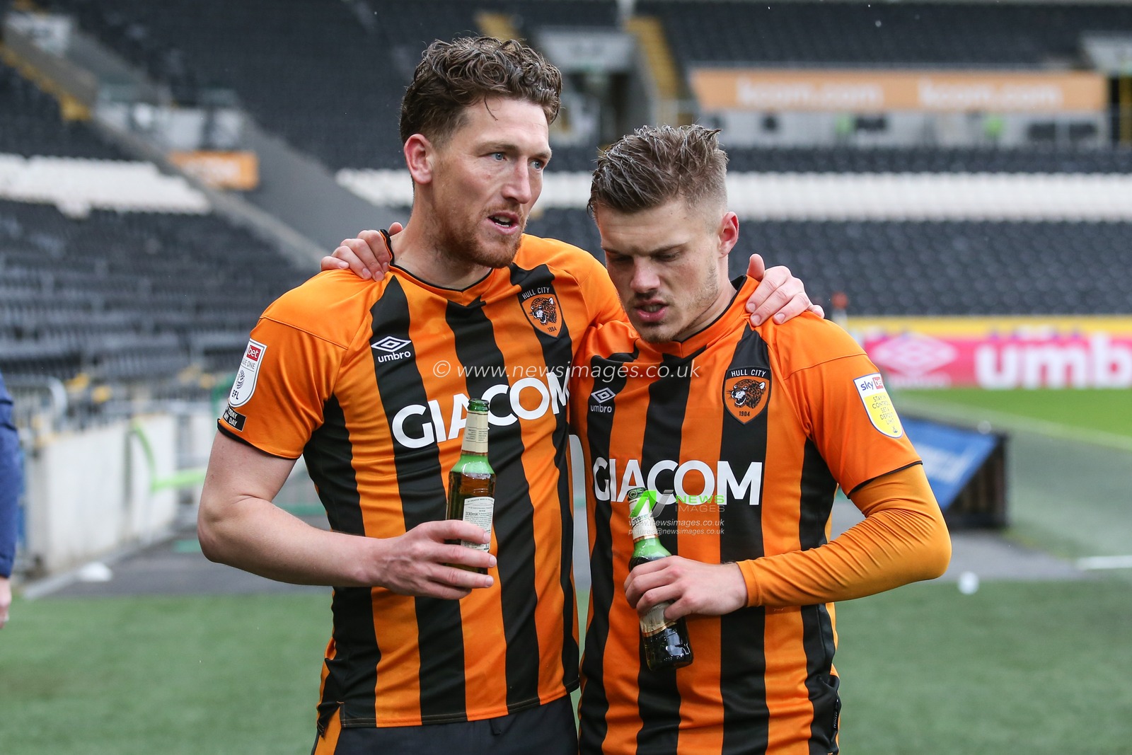 Richard Smallwood #6 and Regan Slater #18 of Hull City celebrate with a beer after the final whistle