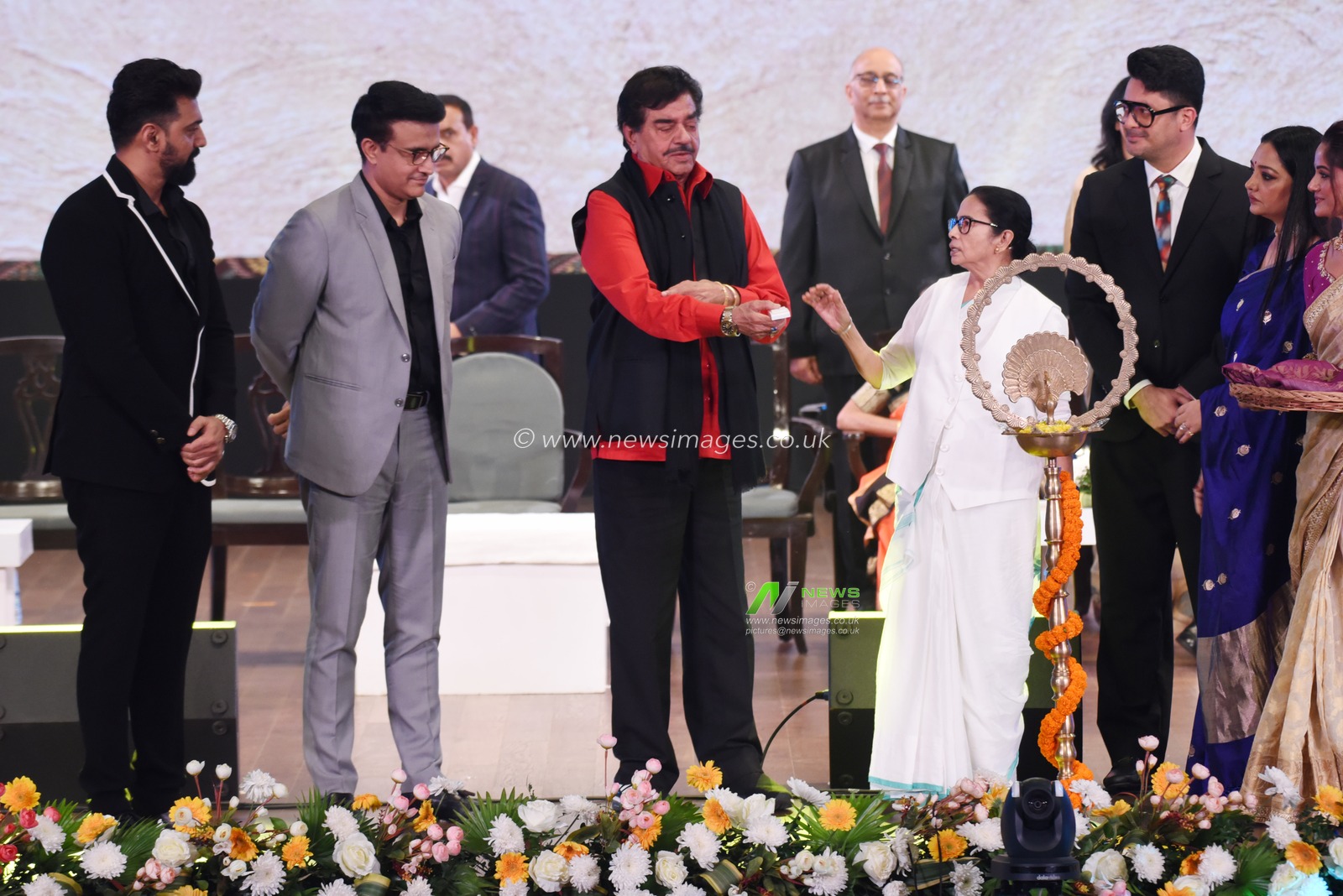 Former Indian cricket team captain Sourav Ganguly , left to 2nd, Chief Minister of West Bengal state Mamata Banerjee, fourth left white dress,  Bollywood actor and lawmaker Shatrughan Sinha, left to 3rd, Actor and MP Dev,June Malia, attend the lamp lighting ceremony during the inauguration of the 30th Kolkata International Film Festival in Kolkata, India,Wednesday, December 4,2024. The festival will continue till Dec. 11.Pictures by Debajyoti Chakraborty.(Photo: Debajyoti Chakraborty/News Images)