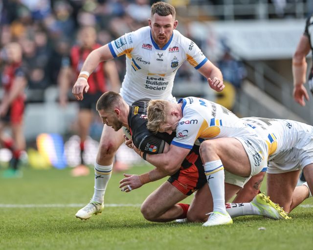 Danny Walker of Warrington Wolves is tackled by James McDonnell of Leeds Rhinos during the Betfred Super League round 6 match Leeds Rhinos vs Warrington Wolves at AMT Headingley Stadium, Leeds, United Kingdom on 29 March 2026

(Photo by Mark Cosgrove/News Images)
