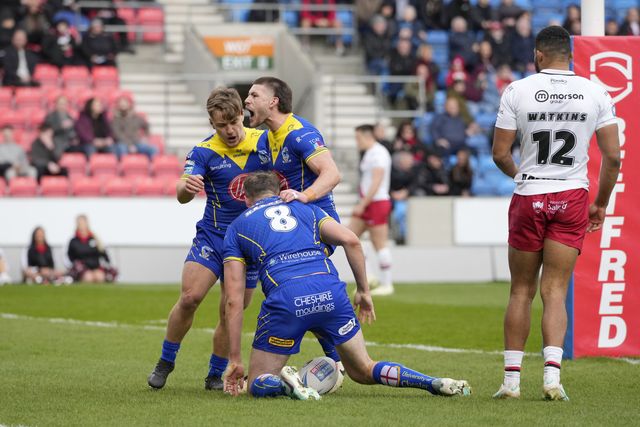 Leon Hayes of Warrington Wolves  and Danny Walker of Warrington Wolves celebrate with try scorer James Harrison of Warrington Wolves during the Betfred Super League Round 9 match Salford Red Devils vs Warrington Wolves at Salford Community Stadium, Eccles, United Kingdom, 27th April 2024

(Photo by Steve Flynn/News Images)