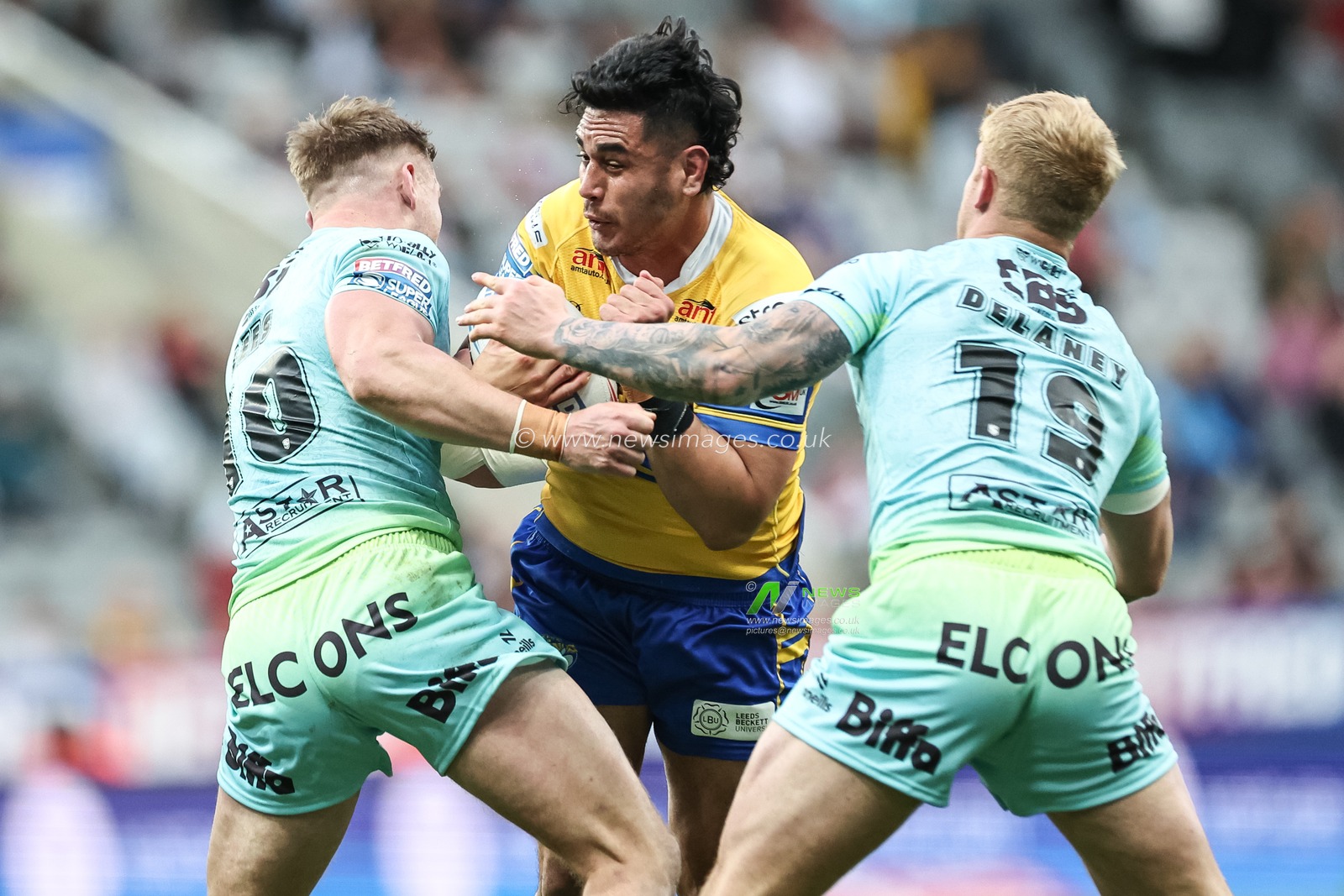 Keenan Palasia of Leeds Rhinos is tackled by Matty Lees of St. Helens and George Delaney of St. Helens during the Betfred Magic Weekend 2025 match St Helens vs Leeds Rhinos at St. James's Park, Newcastle, United Kingdom, 3rd May 2025

(Photo by Mark Cosgrove/News Images)