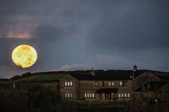 Today's Hunter's Supermoon sets over Grange Moor near Huddersfield