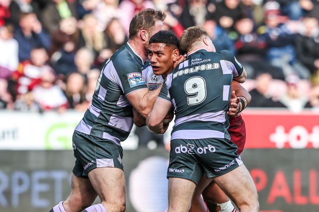 Patrick Mago of Wigan Warriors is tackled by Tom Burgess of Huddersfield Giants and Zac Woolford of Huddersfield Giants during the Betfred Super League round 6 match Wigan Warriors vs Huddersfield Giants at The Brick Community Stadium, Wigan, United Kingdom on 28 March 2026

(Photo by Alfie Cosgrove/News Images)