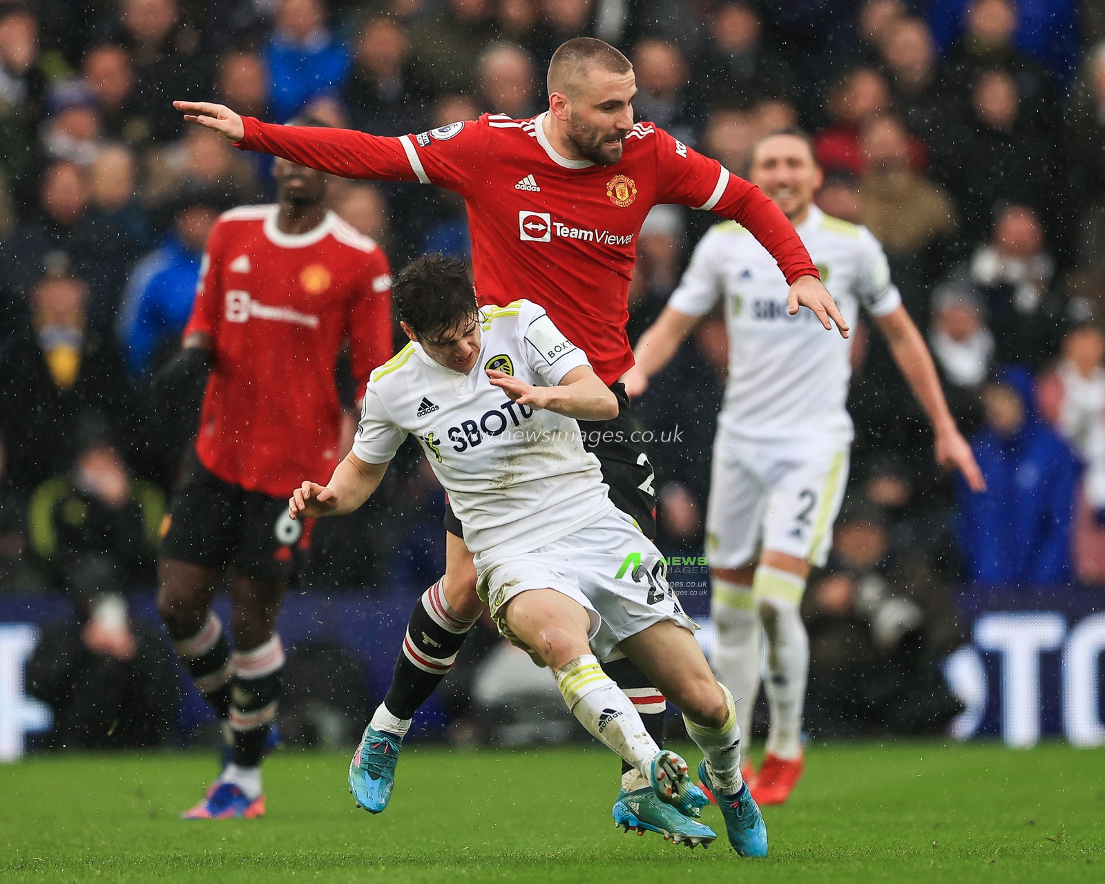 Daniel James #20 of Leeds United is fouled by Luke Shaw #23 of Manchester United
