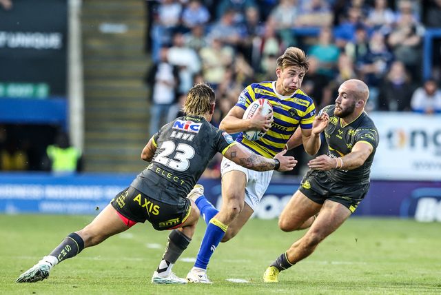Ewan Irwin of Warrington Wolves is tackled by Danny Levi of Leeds Rhinos during the Betfred Super League round 15 match Warrington Wolves vs Leeds Rhinos at The Halliwell Jones Stadium, Warrington, United Kingdom on 18 June 2026

(Photo by Alfie Cosgrove/News Images)