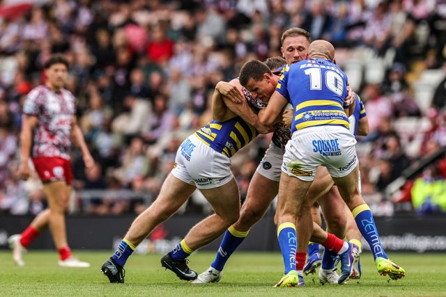 Innes Senior of Leigh Leopards is tackled by James Harrison of Warrington Wolves and Ben Currie of Warrington Wolves during the Betfred Super League round 20 match Leigh Leopards vs Warrington Wolves at Leigh Sports Village, Leigh, United Kingdom on 25 July 2026

(Photo by Alfie Cosgrove/News Images)