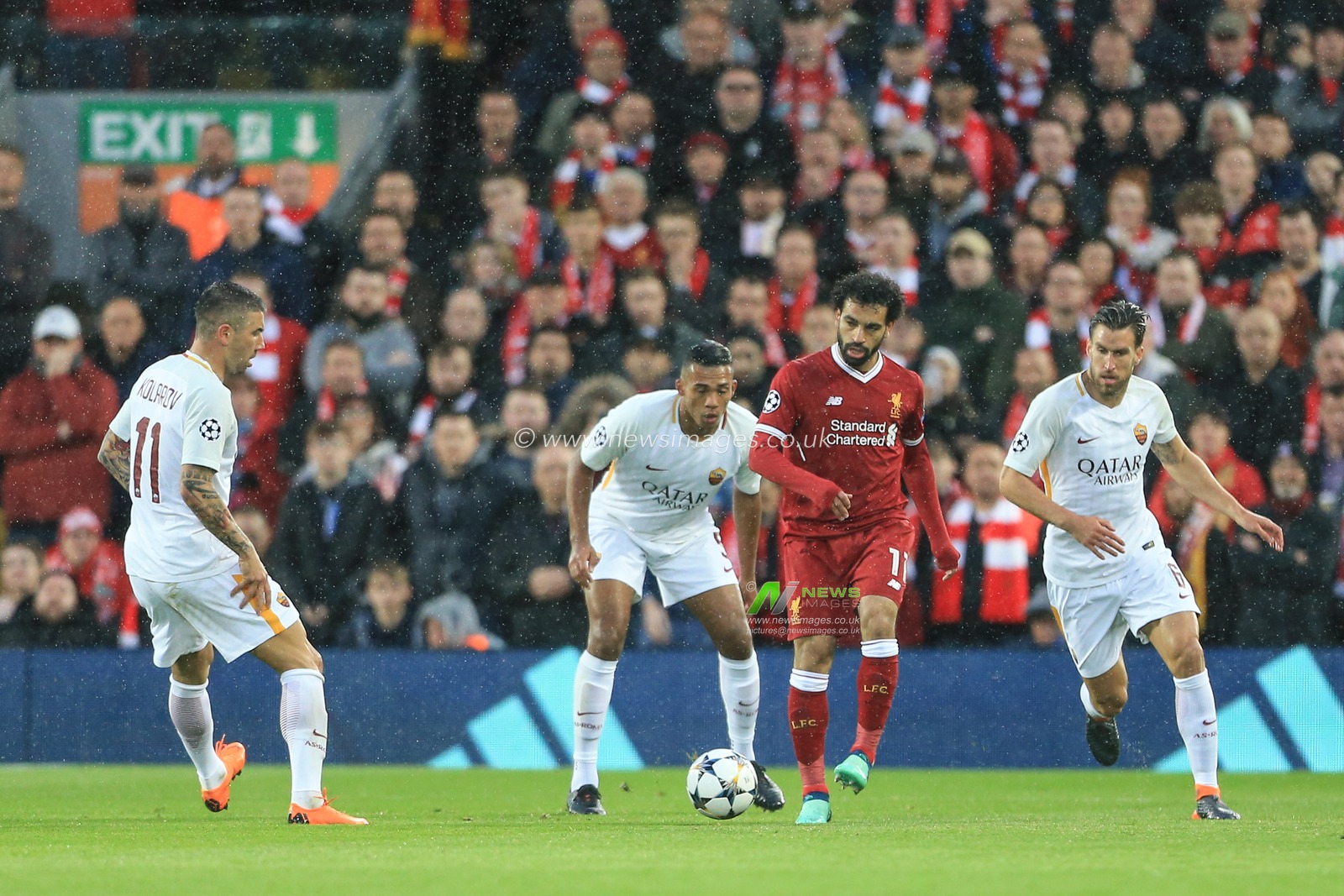 24th April 2018 , Anfield, Liverpool, England; UAFA Champions League Semi Final, first leg, Liverpool v Roma ; Mohamed Salah of Liverpool passes the ball as he comes under pressure