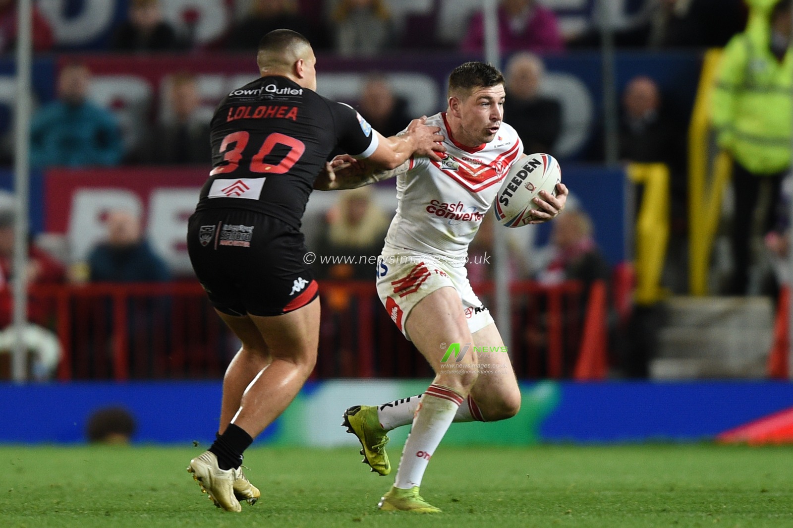 12th October 2019, Old Trafford, Manchester, England; The Grand Final 2019, Saint Helens v Salford Red Devils : Mark Percival (4) of Saint Helens is tackled by Tuimoala Lolohea (30) of Salford Red Devils 

Credit: Richard Long/News Images