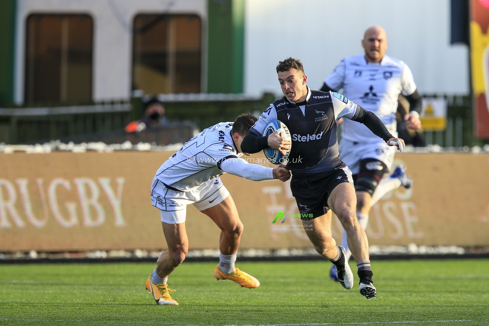 Adam Radwan of Newcastle Falcons skips past Jonny May of Gloucester Rugby
