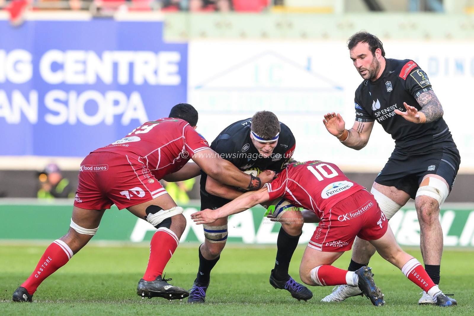 Scott Cummings of Glasgow Warriors is tackled by Carwyn Tuipulotu and Sam Costelow of Scarlets  during the European Challenge Cup Semi-Final match Llanelli Scarlets vs Glasgow Warriors at Parc y Scarlets, Llanelli, United Kingdom, 29th April 2023

(Photo by Craig Thomas/News Images)