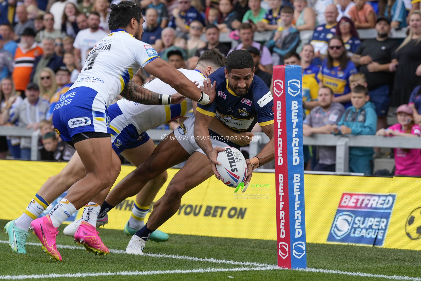 Pete Mataâ€™utia #3 of Warrington Wolves and Josh Thewlis #2 of Warrington Wolves push Nene Macdonald #4 of Leeds Rhinos  into touch close to the try line during the Betfred Super League Round 22 match Leeds Rhinos vs Warrington Wolves at Headingley Stadium, Leeds, United Kingdom, 20th August 2023

(Photo by Steve Flynn/News Images)