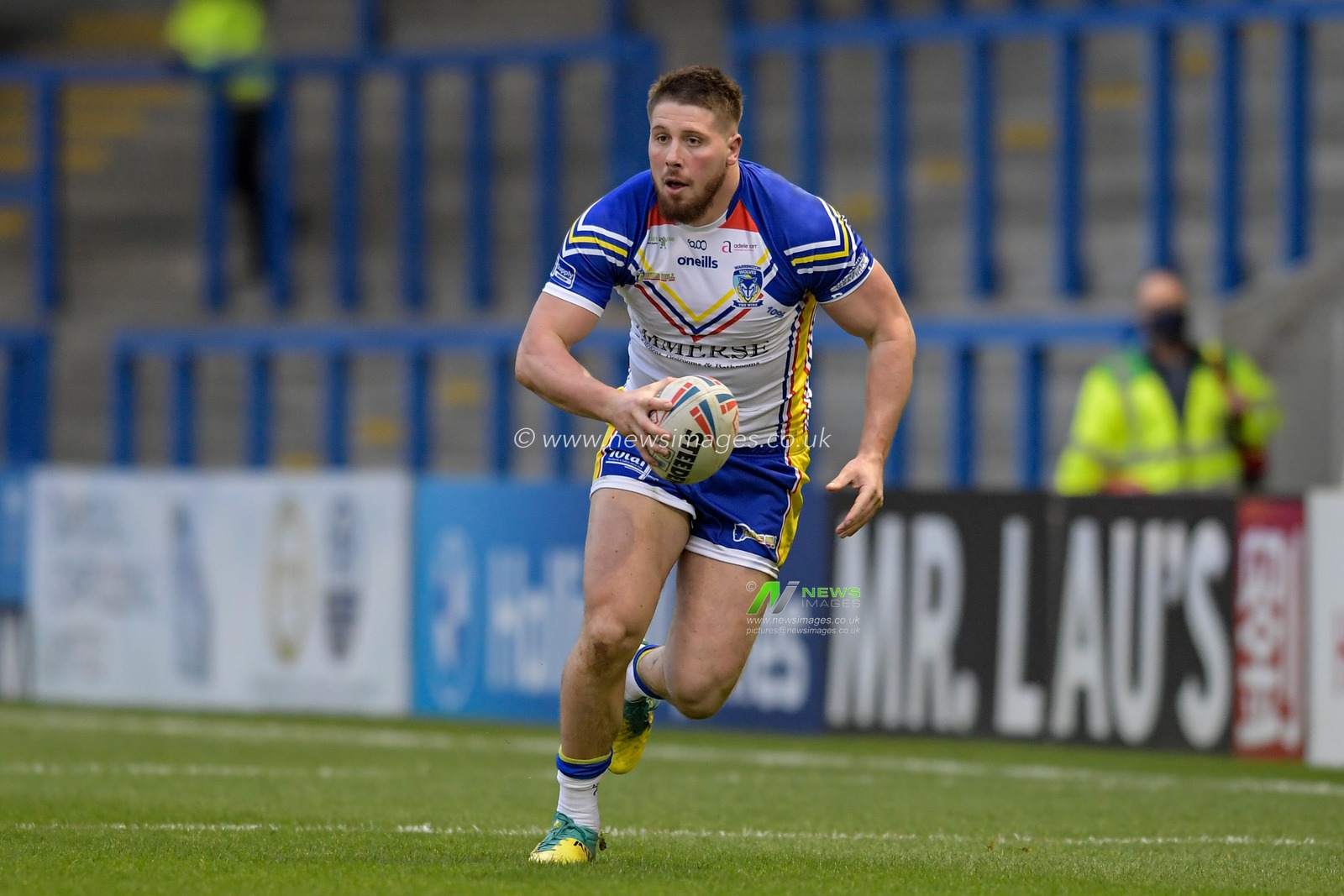 Tom Lineham (2) of Warrington Wolves runs forward with the ball