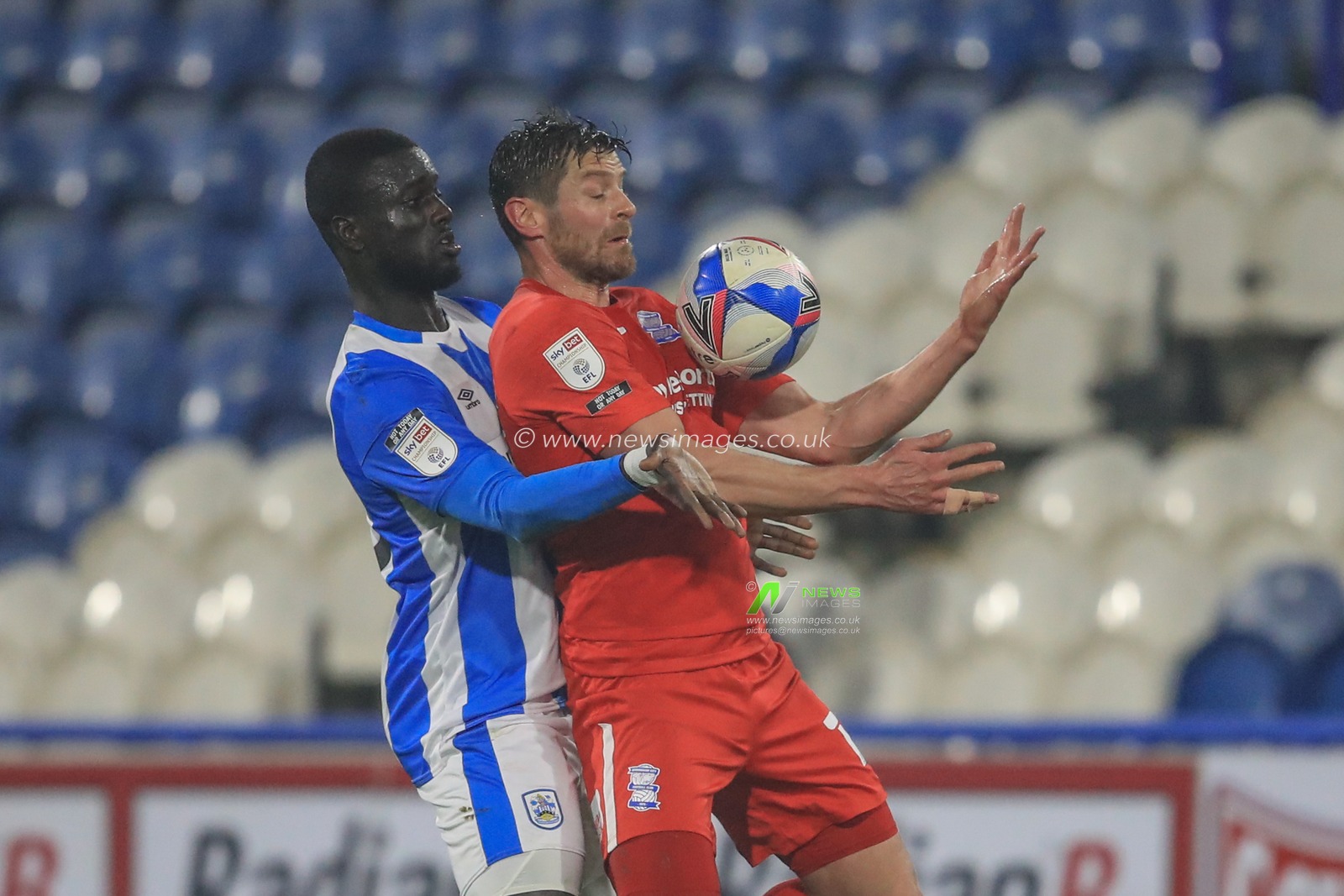 Lukas Jutkiewicz #10 of Birmingham City controls the balls as Mouhamadou-Naby Sarr #23 of Huddersfield Town pressures