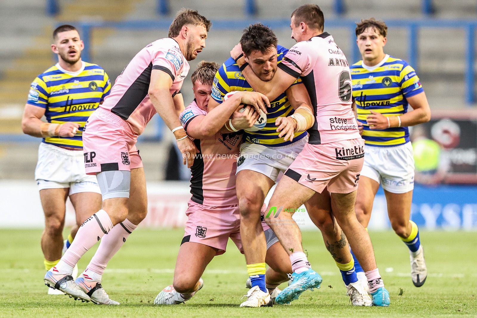 Liam Byrne of Warrington Wolves is tackled by Harvie Hill of Hull FC and Jake Arthur of Hull FC during the Betfred Super League round 13 match Warrington Wolves vs Hull FC at The Halliwell Jones Stadium, Warrington, United Kingdom on 05 June 2026

(Photo by Alfie Cosgrove/News Images)