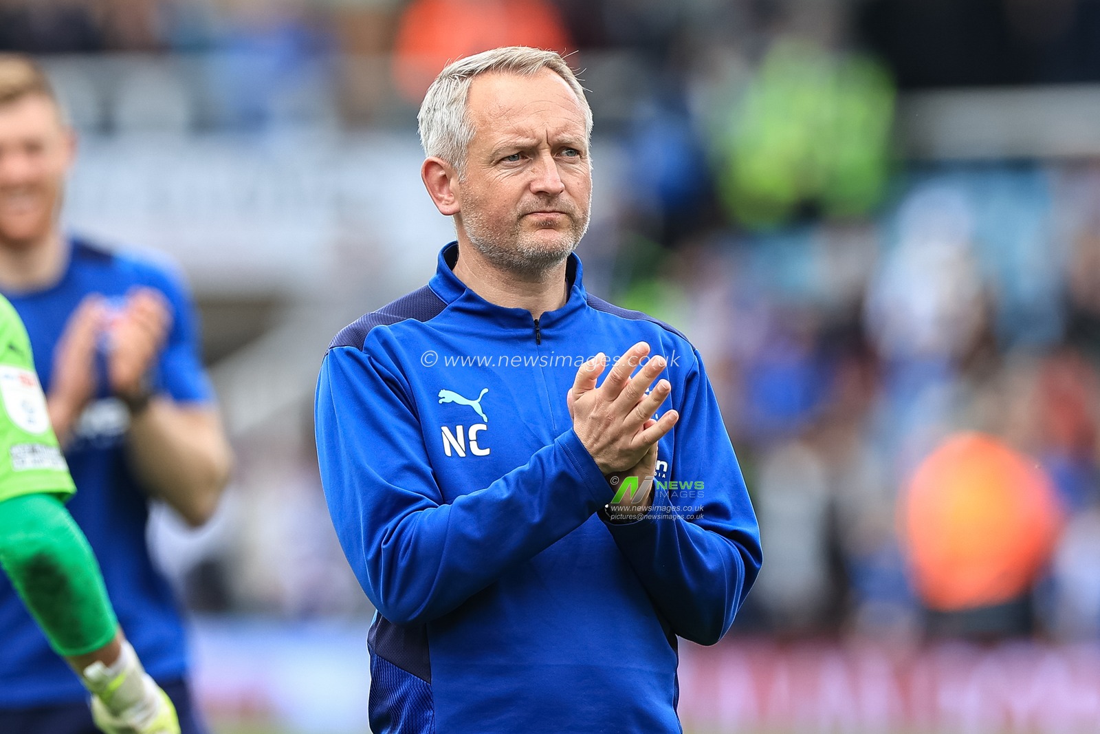 Neil Critchley head coach of Blackpool applauds the traveling fans