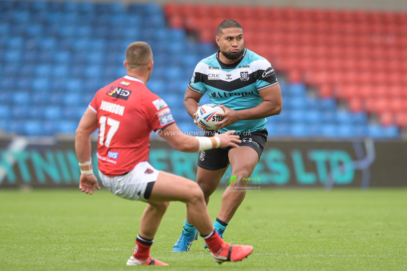 Chris Satae (10) of Hull FC looks for a way past Josh Johnson (17) of Salford Red Devils