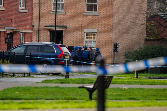 Officers with ordinance unit vests and a dog about to enter an address on Vulcan Street, during a Major Explosives Incident in Derby that began on Thursday December 4 when police executed a warrant at an address on Vulcan Street, Derby, that saw two men arrested on suspicion of explosives offences and 200 homes evacuated (Maynard Manyowa / News Images)
