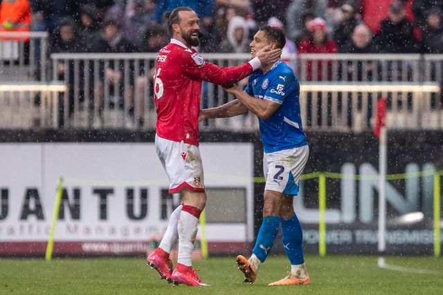 Wrexham's Steven Fletcher and Stockport County's Kyle Knoyle share a funny moment during the Sky Bet League 1 match Wrexham vs Stockport County at SToK Cae Ras, Wrexham, United Kingdom, 22nd March 2025

(Photo by Nik Mesney/News Images)