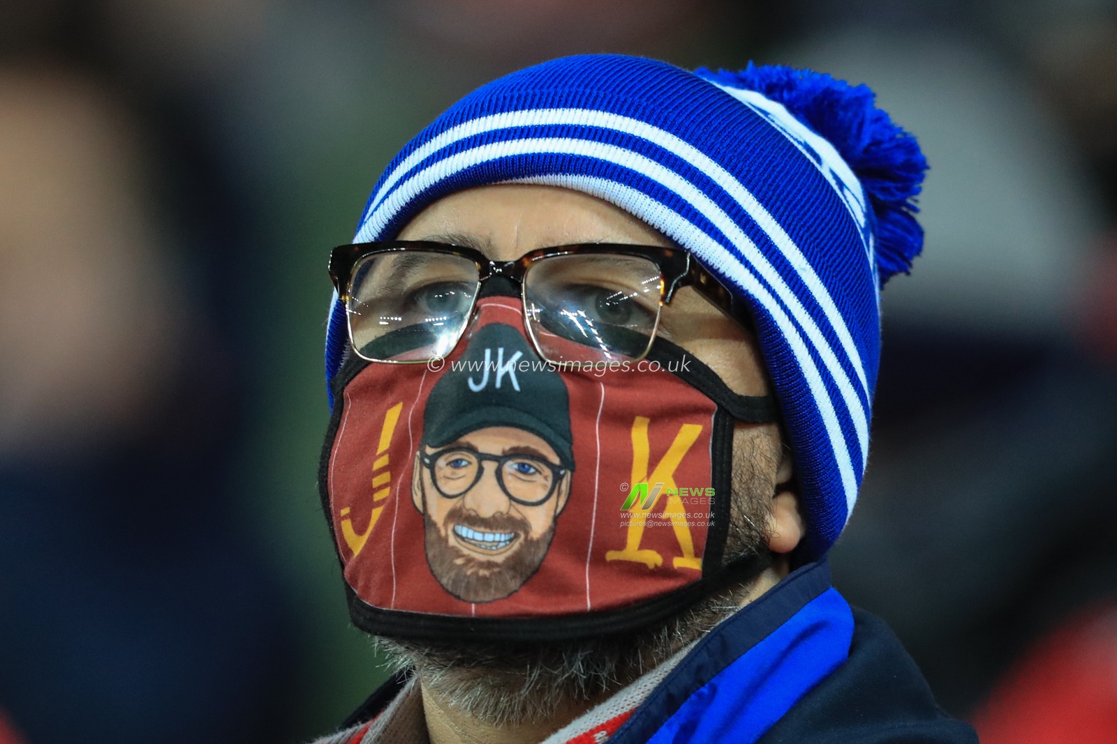 A Liverpool fan with a JÃ¼rgen Klopp manager of Liverpool face mask on