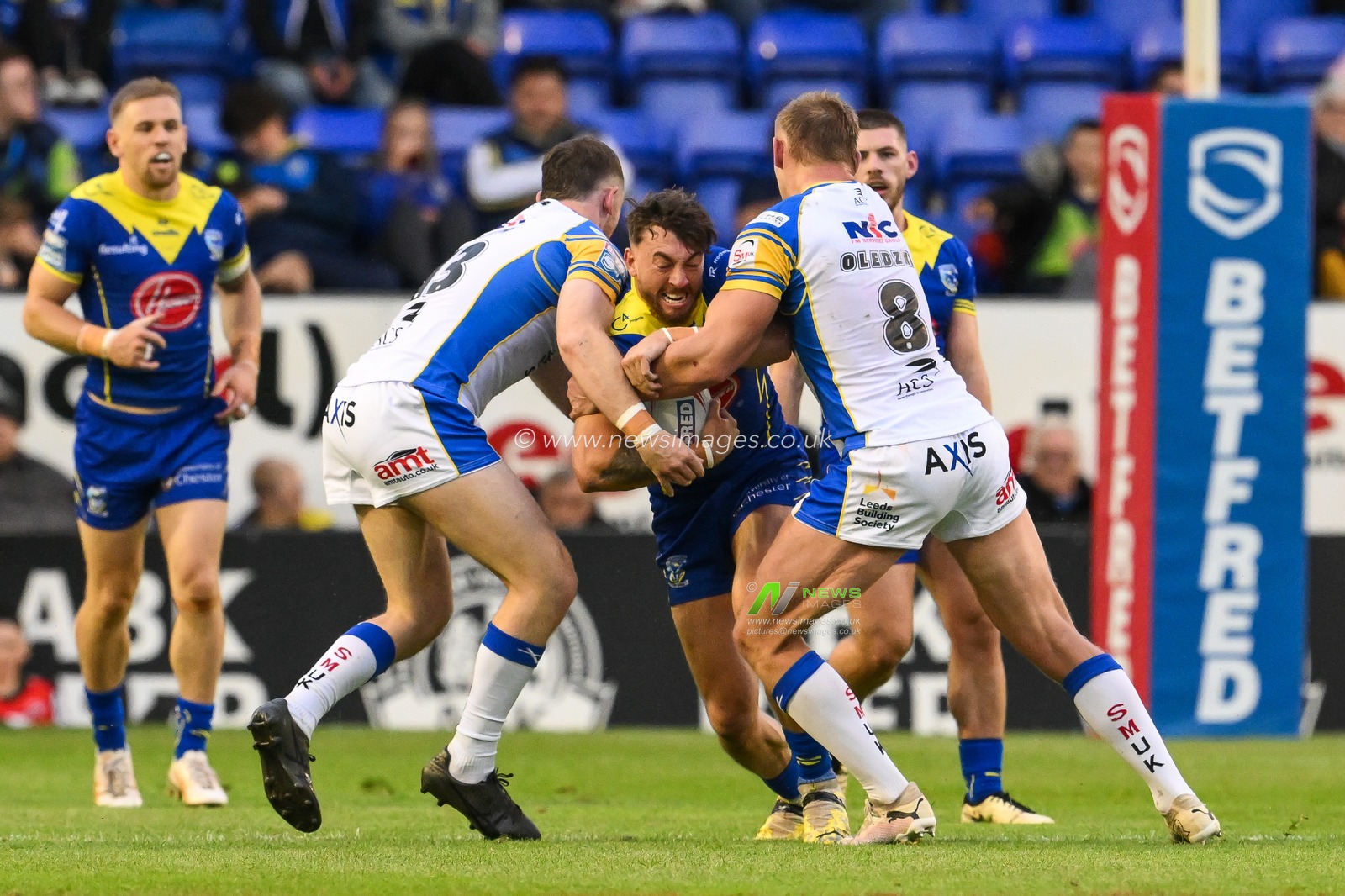 Matty Ashton of Warrington Wolves is tackled by Mikolaj Oledzki of Leeds Rhinos and Cameron Smith of Leeds Rhinos during the Betfred Super League Round 17 match Warrington Wolves vs Leeds Rhinos at Halliwell Jones Stadium, Warrington, United Kingdom, 11th July 2024

(Photo by Craig Thomas/News Images)