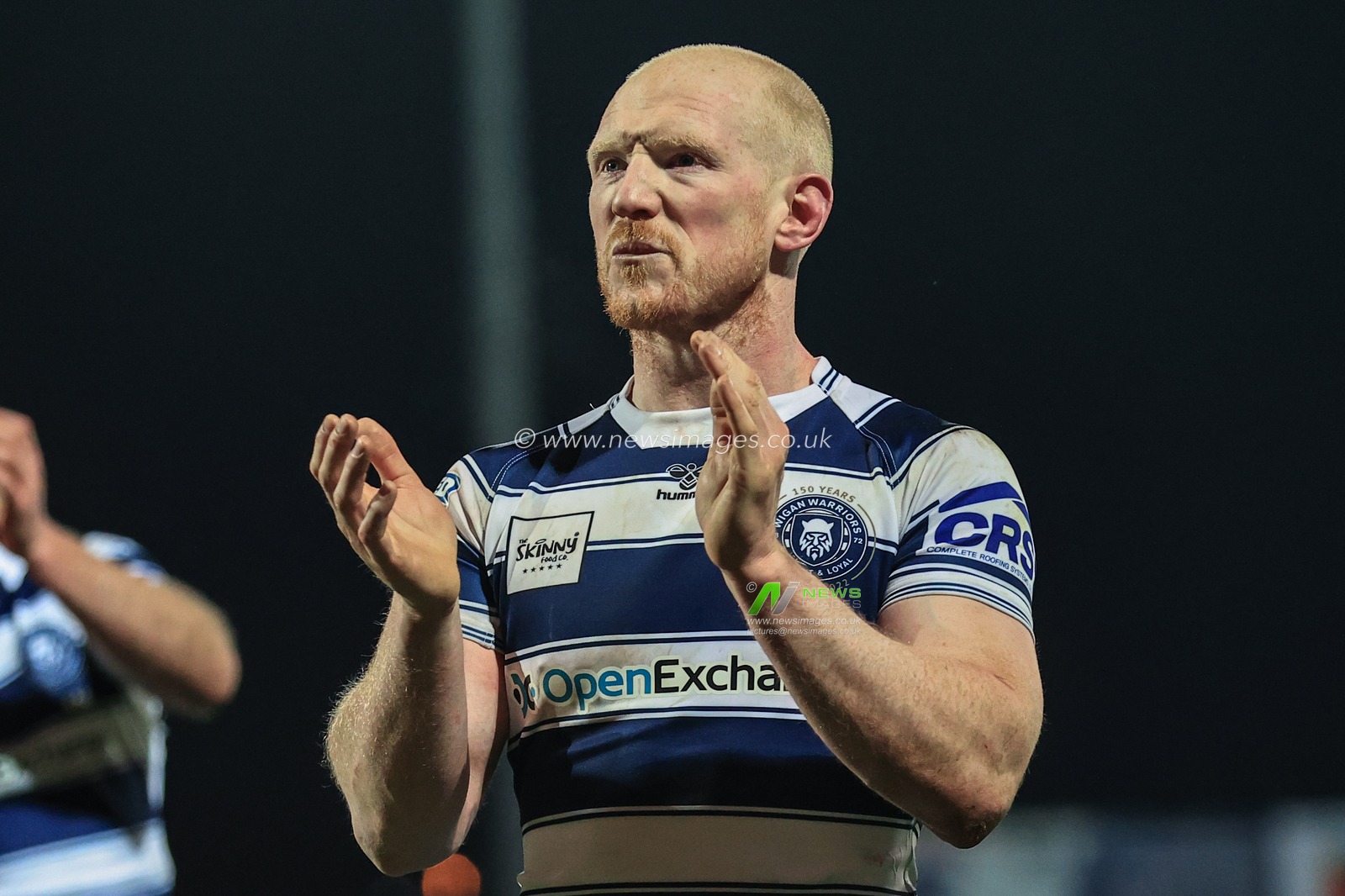Liam Farrell #12 of Wigan Warriors applauds the traveling fans as Wigan win Hull KR 10-24