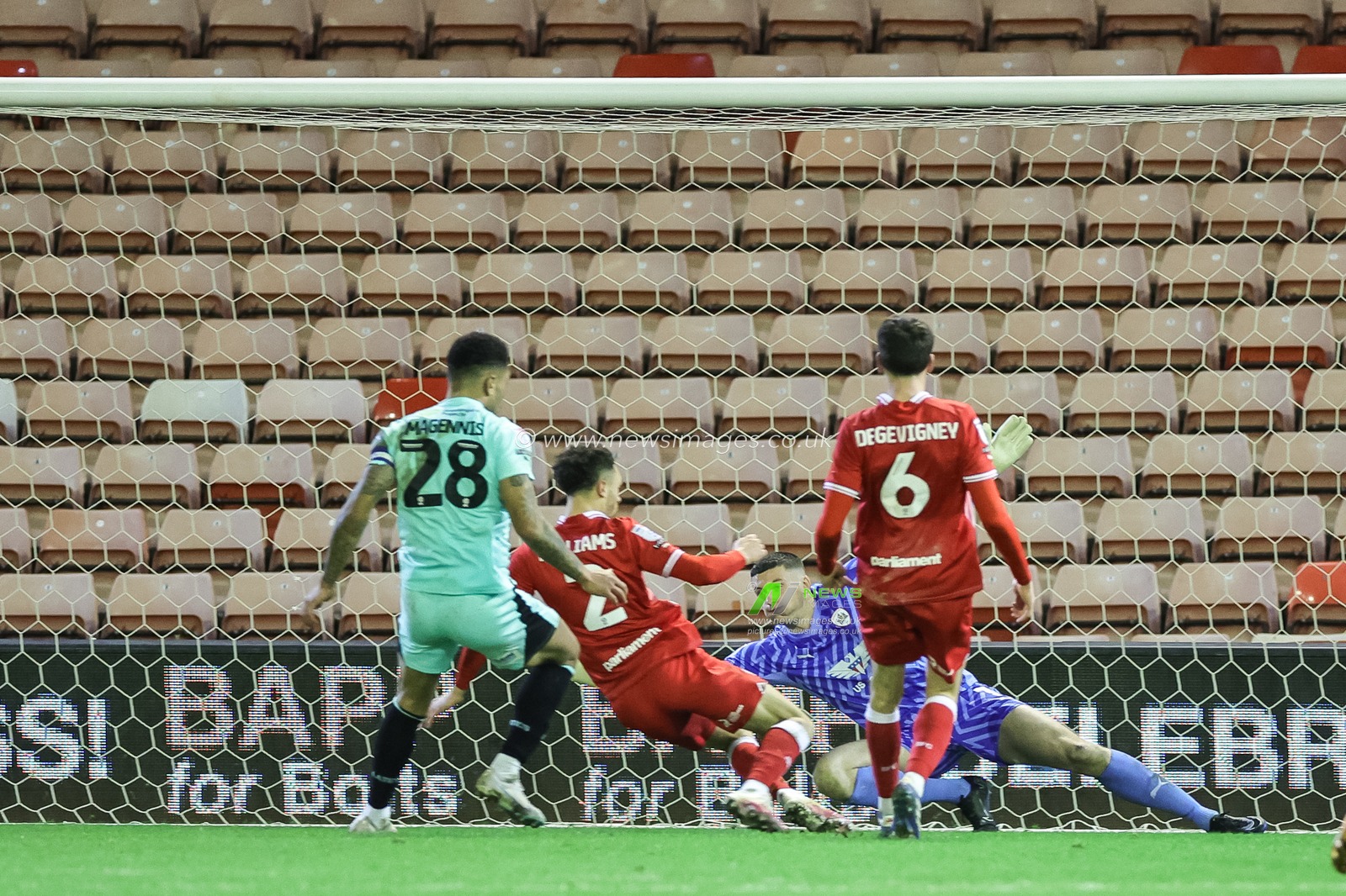 Liam Roberts of Barnsley makes a save under the bar during the Sky Bet League 1 match Barnsley vs Wigan Athletic at Oakwell, Barnsley, United Kingdom, 1st January 2024

(Photo by Mark Cosgrove/News Images)