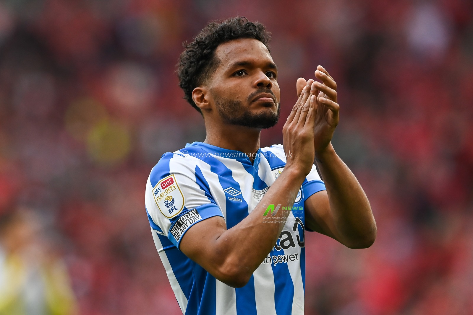 Duane Holmes #19 of Huddersfield Town applauds the fans at the end of the game
