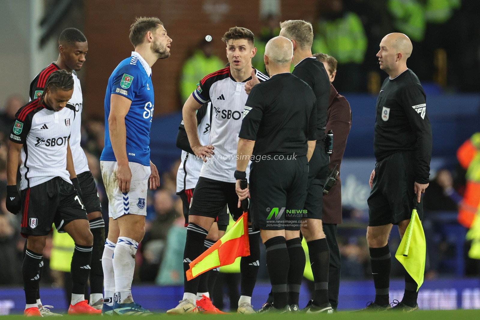 Referee Graham Scott talks to James Tarkowski of Everton and Tom Cairney of Fulham during the Carabao Cup Quarter Final match Everton vs Fulham at Goodison Park, Liverpool, United Kingdom, 19th December 2023

(Photo by Mark Cosgrove/News Images)