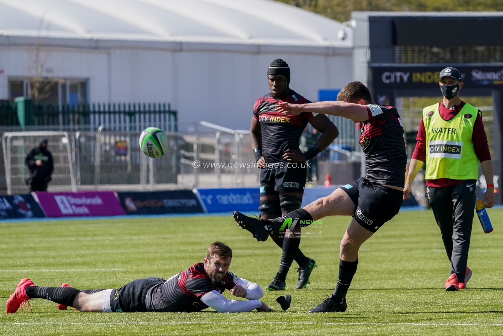 Elliot Daly #13 of Saracens holds the ball for  Owen Farrell #10 of Saracens for a penalty kick