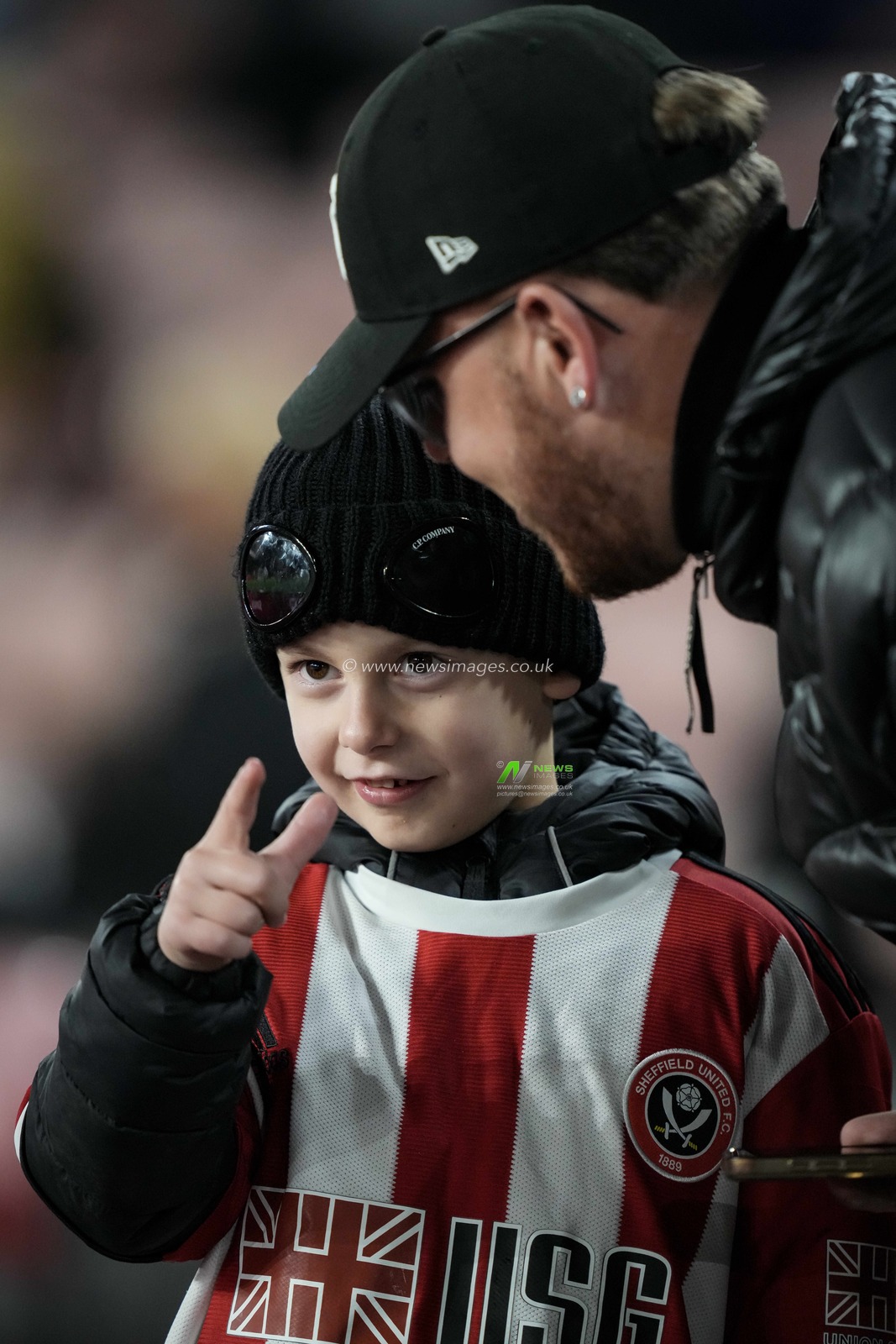 A Sheffield United young fan points to players warming up during the Sky Bet Championship match Sheffield United vs Norwich City at Bramall Lane, Sheffield, United Kingdom, 9th December 2025

(Photo by Maynard Manyowa/News Images)

*** GER AUT SUI OUT ***