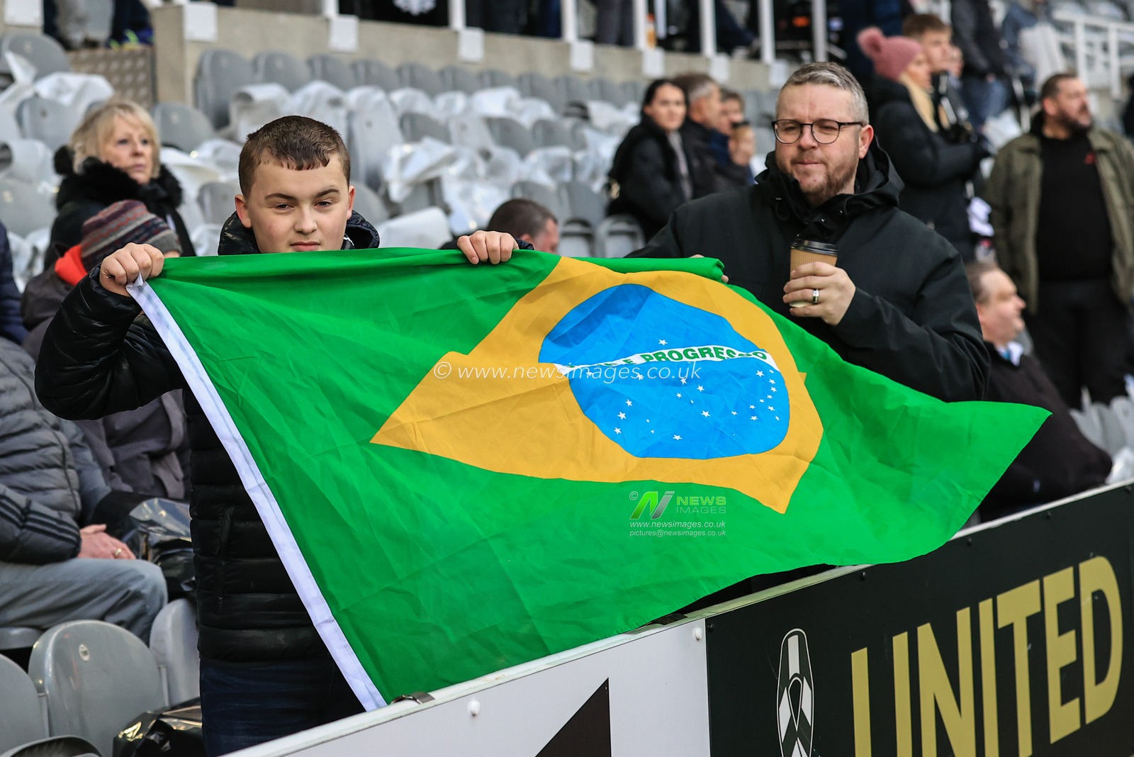 Newcastle United fans with a Brazilian flag