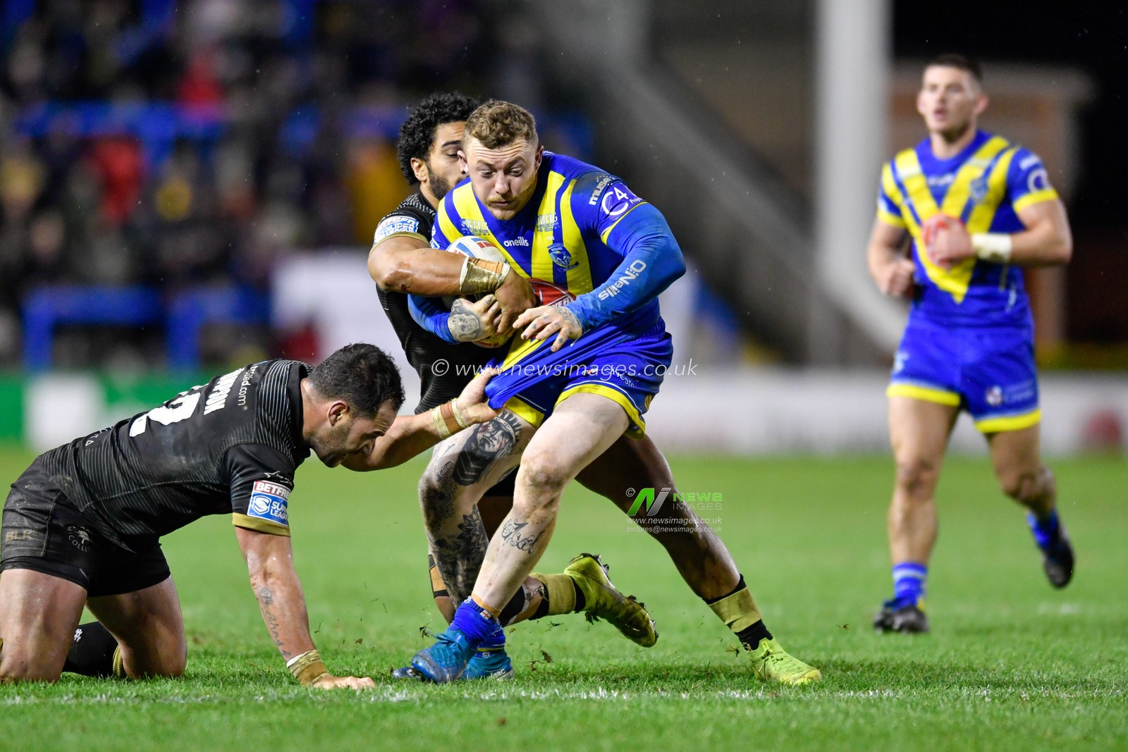 21st February 2020, Halliwell Jones Stadium, Warrington, England; Betfred Super League, Warrington Wolves v Toronto Wolfpack : Josh Charnley (5) of Warrington Wolves is tackled by Ricky Leutele (4) and Bodene Thompson (12) of Toronto Wolfpack