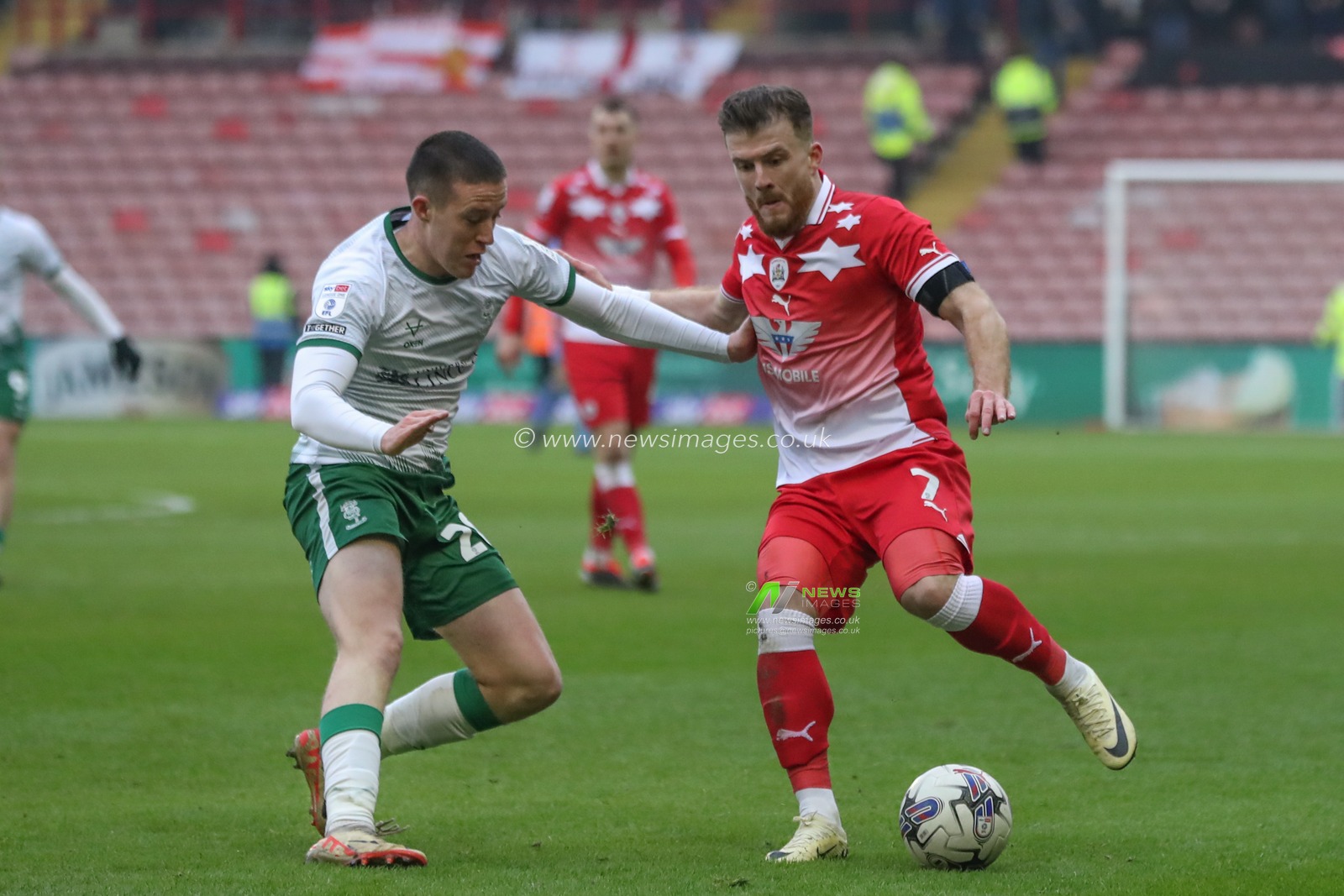 Nicky Cadden of Barnsley and Jack Moylan of Lincoln City battle for the ball during the Sky Bet League 1 match Barnsley vs Lincoln City at Oakwell, Barnsley, United Kingdom, 9th March 2024

(Photo by Alfie Cosgrove/News Images)