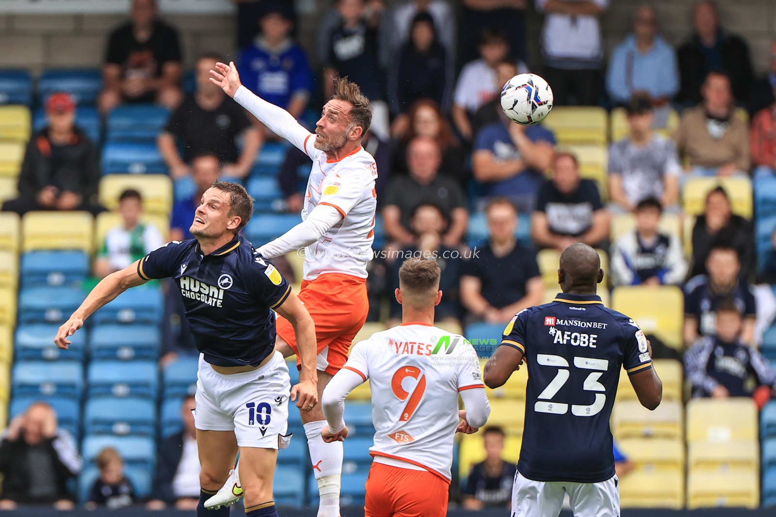 Richard Keogh #26 of Blackpool  wins the high-all from Matt Smith #10 of Millwall