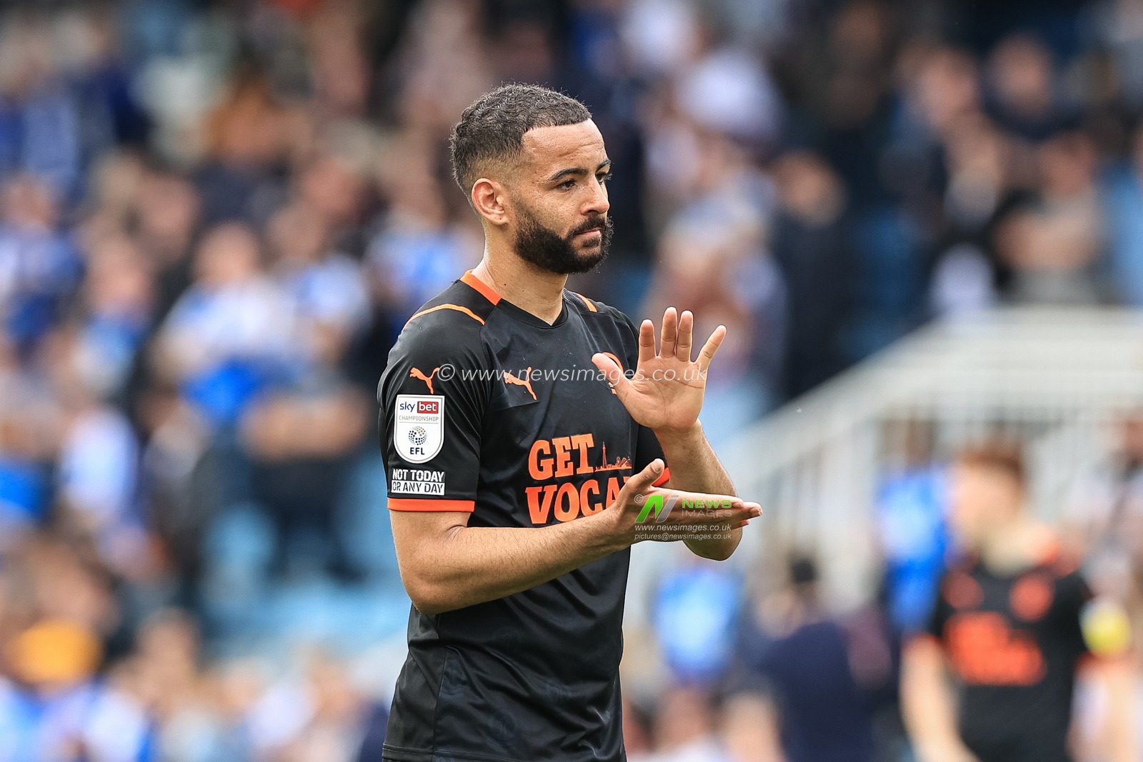 Kevin Stewart #6 of Blackpool applauds the traveling fans