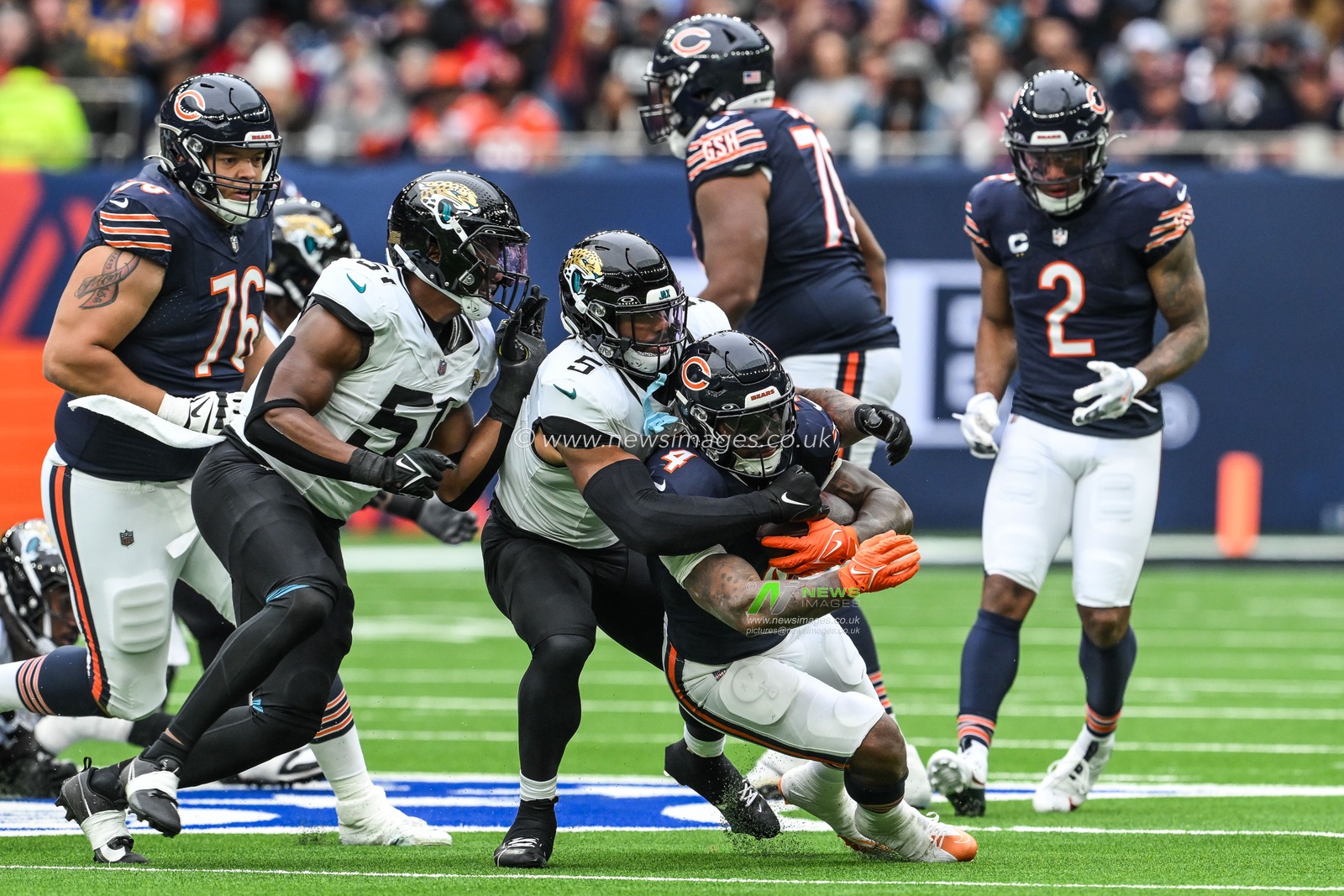 D'Andre Swift of the Chicago Bears is tackled by Andre Cisco of the Jacksonville Jaguars during the Week 6 match Chicago Bears vs Jacksonville Jaguars at Tottenham Hotspur Stadium, London, United Kingdom, 13th October 2024

(Photo by Craig Thomas/News Images)