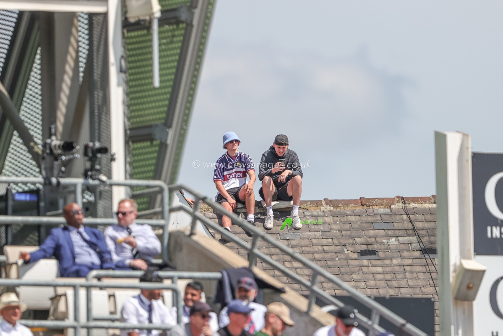 Two youngsters sit on the roof of an adjacent house watching the game during the LV= Insurance Ashes Third Test Series Day 2 England v Australia at Headingley Stadium, Leeds, United Kingdom, 7th July 2023

(Photo by Mark Cosgrove/News Images)