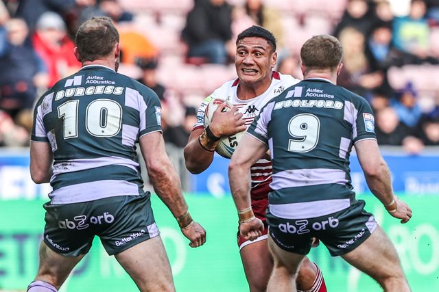 Patrick Mago of Wigan Warriors is tackled by Tom Burgess of Huddersfield Giants and Zac Woolford of Huddersfield Giants during the Betfred Super League round 6 match Wigan Warriors vs Huddersfield Giants at The Brick Community Stadium, Wigan, United Kingdom on 28 March 2026

(Photo by Alfie Cosgrove/News Images)
