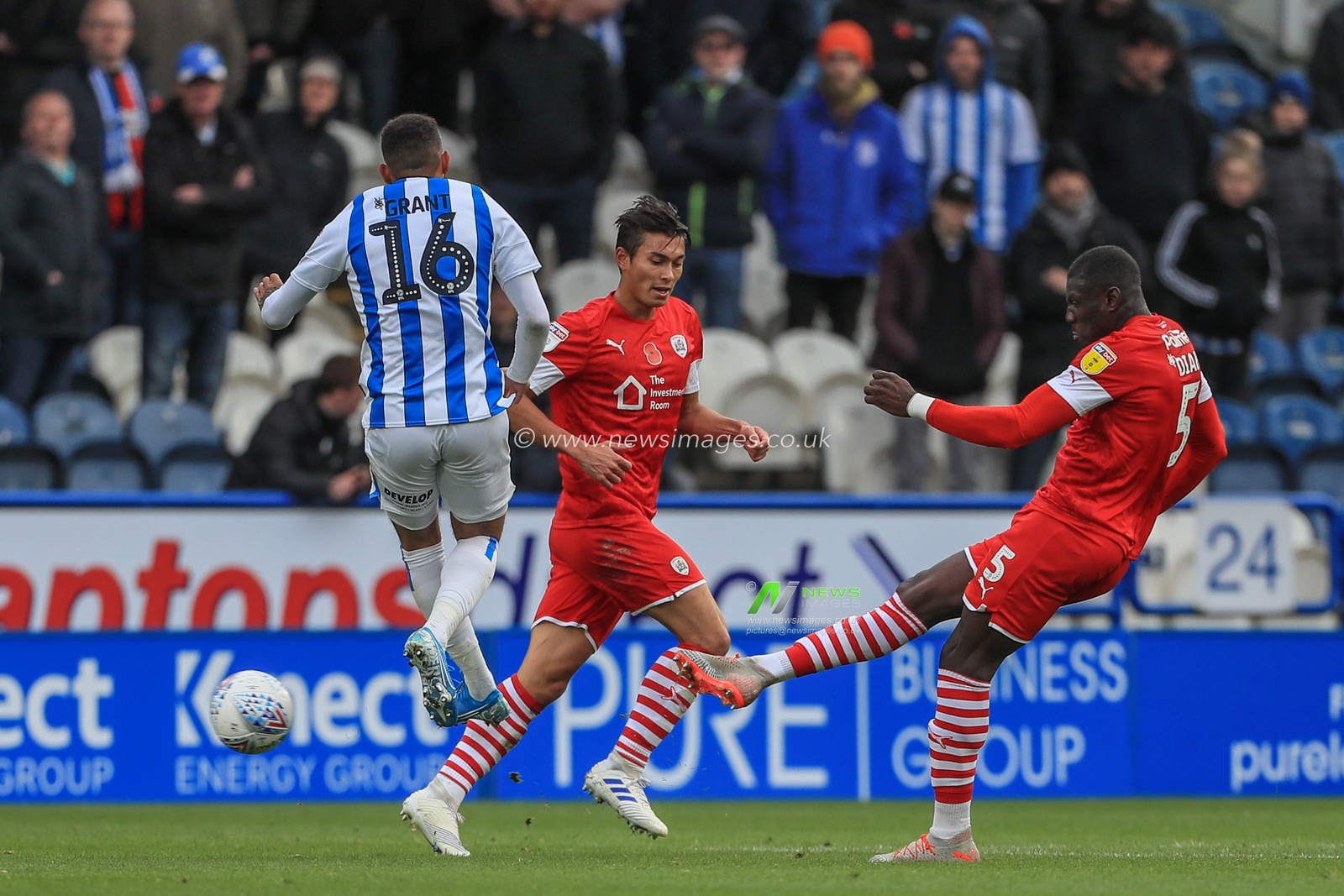 26th October 2019, John Smith's Stadium, Huddersfield, England; Sky Bet Championship, Huddersfield Town v Barnsley : Bambo Diaby (5) of Barnsley clears the ball up field as Karlan Grant (16) of Huddersfield Town tries to block it 

Credit: Mark Cosgrove/News Images