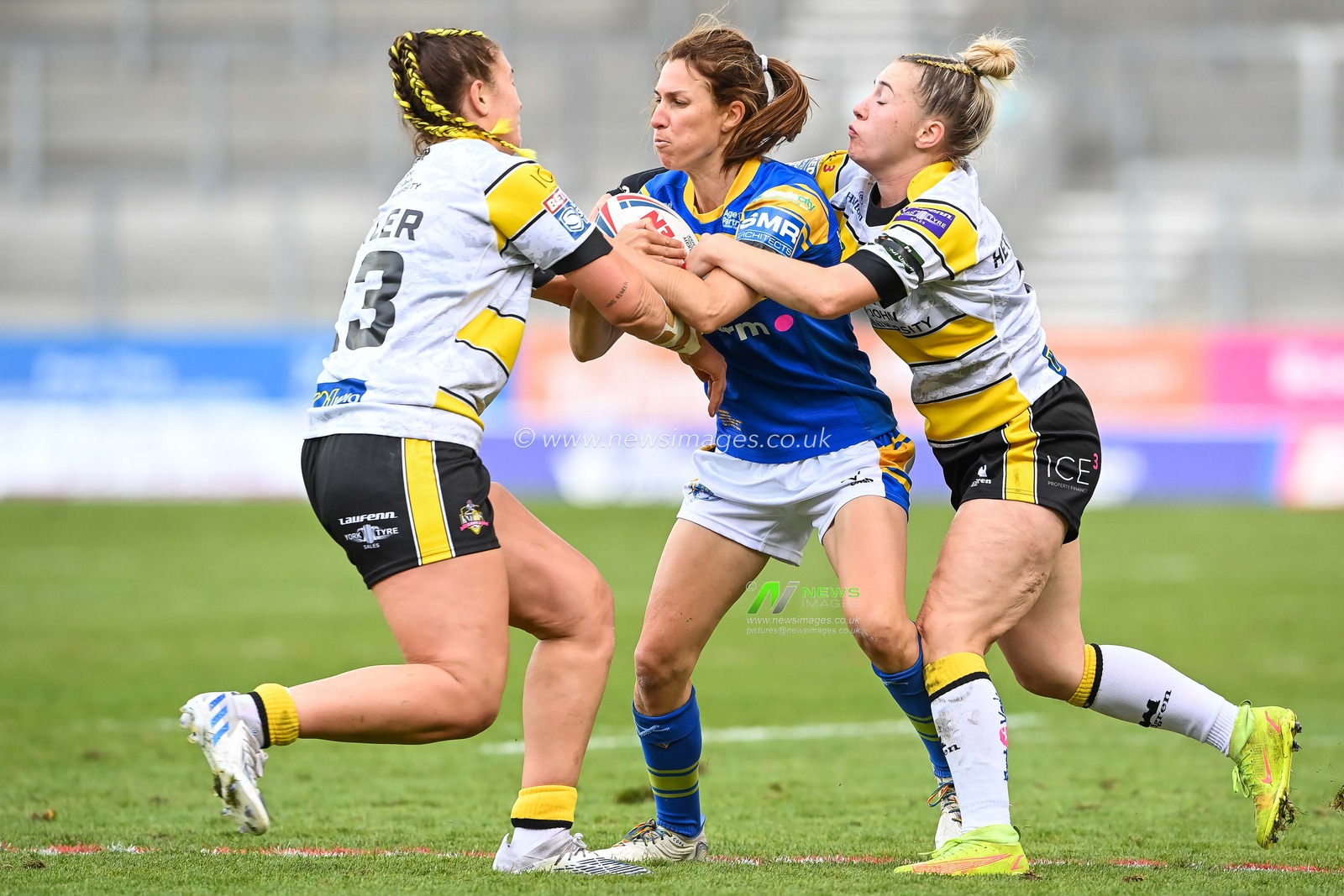 Courtney Winfield-Hill of Leeds Rhinos Women is tackled by Matilda Butle and Georgie Hetherington of York City Knights Women during the Betfred Women's Super League Grand Final York CIty Knights Women vs Leeds Rhinos Women at Totally Wicked Stadium, St Helens, United Kingdom, 18th September 2022

(Photo by Craig Thomas/News Images)