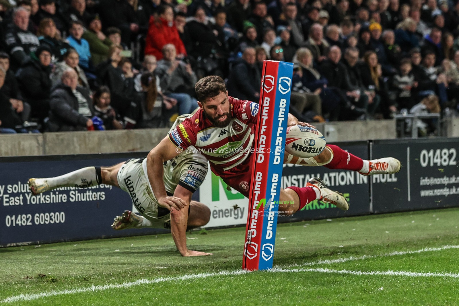 Tom Briscoe of Hull FC tackles Abbas Miski of Wigan Warriors to stop him going over for a try during the Betfred Super League Round 2 match Hull FC vs Wigan Warriors at MKM Stadium, Hull, United Kingdom, 21st February 2025

(Photo by Alfie Cosgrove/News Images)