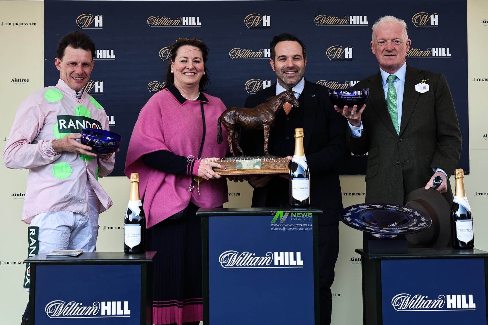 Jockey Paul Townend, Owner Susannah Ricci and trainer Willie Mullins with winners trophies after the William Hill Aintree Hurdle during the Randox Grand National 2025 Day 1 Opening Day at Aintree Racecourse, Liverpool, United Kingdom, 3rd April 2025

(Photo by Mark Cosgrove/News Images)
