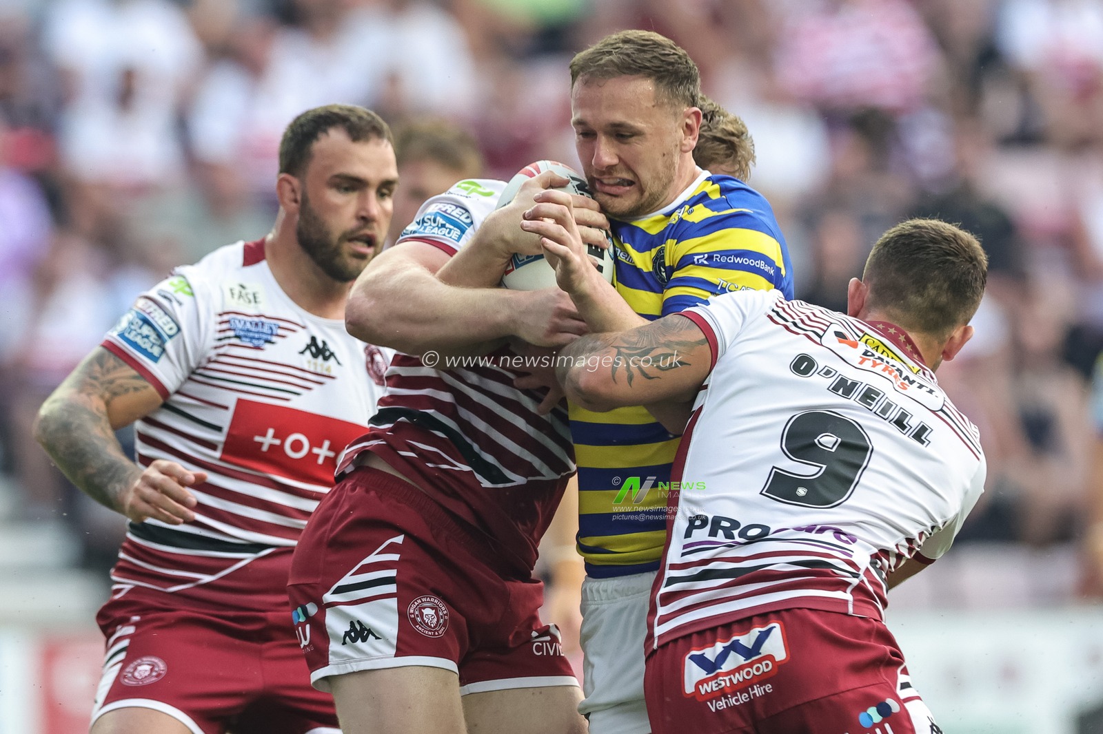 Ben Currie of Warrington Wolves is tackled by Brad O'Neill of Wigan Warriors during the Betfred Super League round 18 match Wigan Warriors vs Warrington Wolves at The Brick Community Stadium, Wigan, United Kingdom on 10 July 2026

(Photo by Mark Cosgrove/News Images)