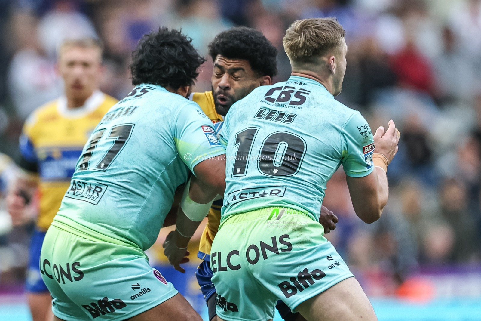 Kallum Watkins of Leeds Rhinos is tackled by Agnatius Paasi of St. Helens and Matty Lees of St. Helens during the Betfred Magic Weekend 2025 match St Helens vs Leeds Rhinos at St. James's Park, Newcastle, United Kingdom, 3rd May 2025

(Photo by Mark Cosgrove/News Images)