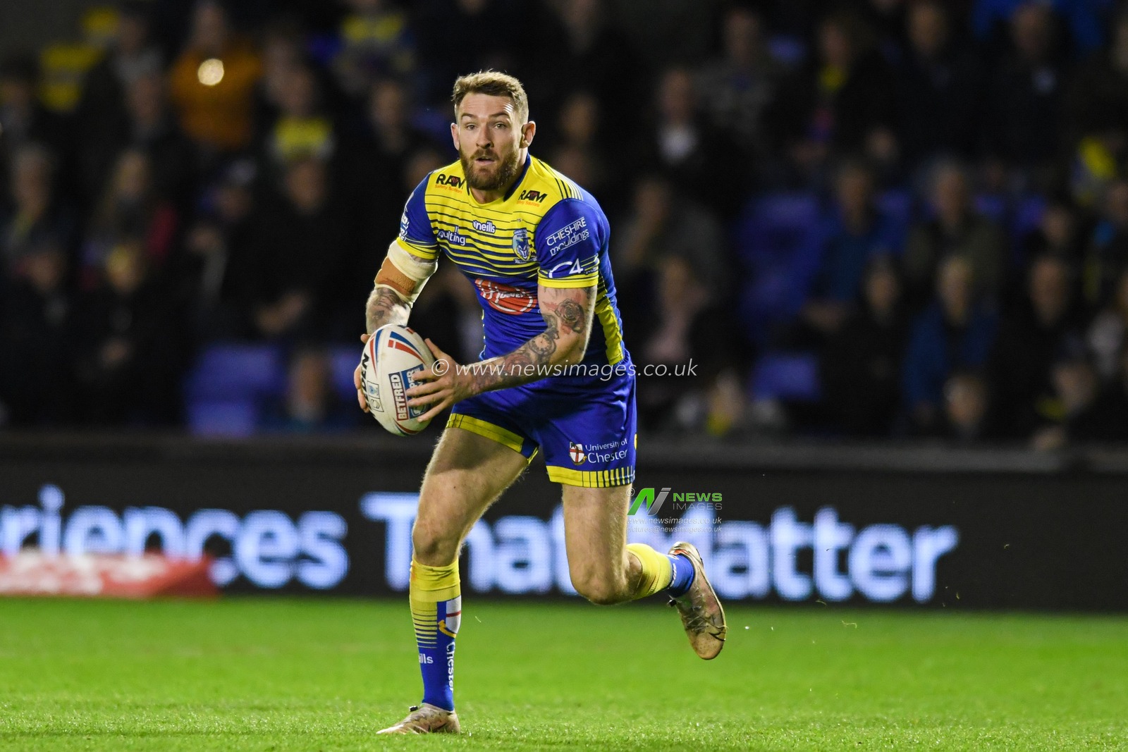 Daryl Clark #9 of Warrington Wolves runs forward with the ball